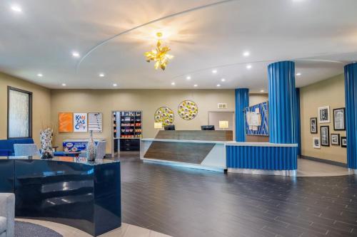 a lobby of a store with blue columns at Holiday Inn Express & Suites Kansas City Airport by IHG in Kansas City
