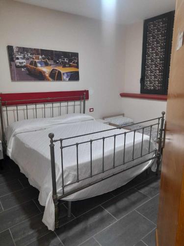 a bedroom with a bed with a metal frame at B&B da Maria & Renato il Lago Trattoria in Mirabella Eclano