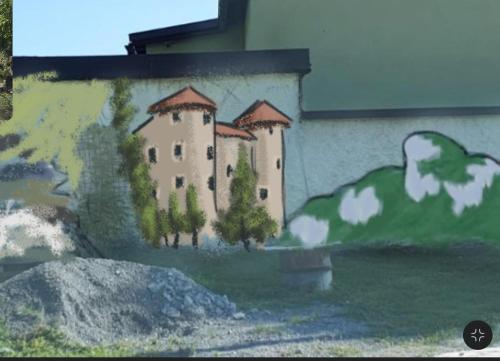 a painting of a castle on the side of a building at Zeleni raj in Hreljin Ogulinski