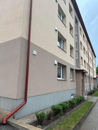 a red hose attached to the side of a building at Sofi Apartment in Võru