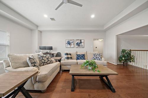 a living room with a couch and a table at Lake Houston Getaway Pool Spa Lake Front in Humble