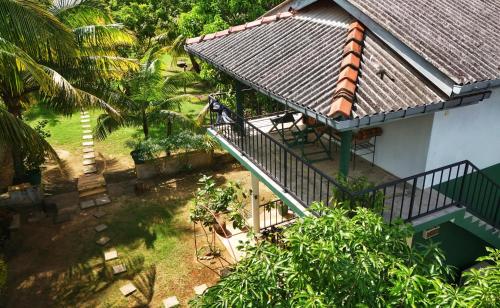 an overhead view of a house with a balcony at Blue skies guest house and restaurant in Tangalle