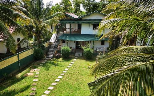 an aerial view of a house with palm trees at Blue skies guest house and restaurant in Tangalle