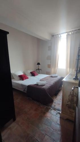 a bedroom with a large bed in a room at Domaine du prieuré Saint Ellier in  Charcé-Saint-Ellier-sur-Aubance