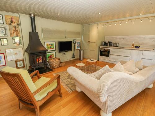 a living room with a couch and a fireplace at Lymington Lodge in Lymington