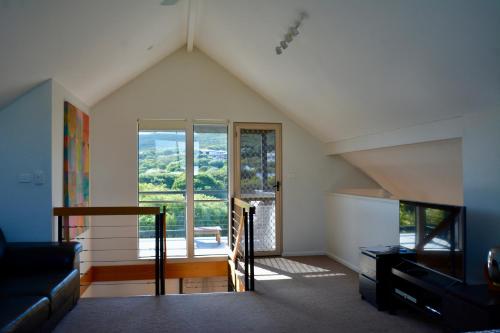 a living room with a large window and a couch at Ocean View Beach House, Margaret River in Gnarabup
