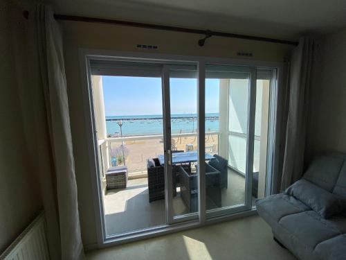 a living room with a view of the ocean at Appartement vue sur mer et le port in Jard-sur-Mer