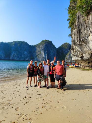 a group of people standing on the beach at Venezia Cruises in Ha Long