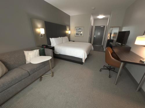 a hotel room with a bed and a couch at Holiday Inn Carlsbad/San Diego by IHG in Carlsbad