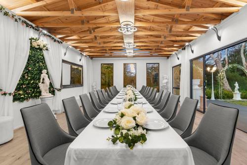 a long table in a room with chairs and a christmas tree at Hacienda Retreat- 25 guests in Capel Sound