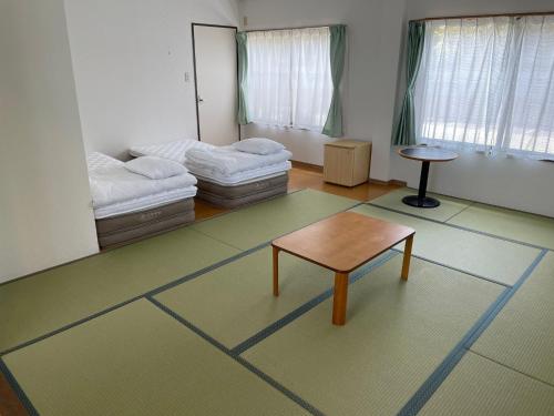a room with two beds and a table in it at Seaside house & Terrace SEAGULL - Vacation STAY 48168v in Towa