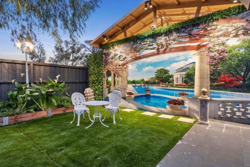 a backyard with a table and chairs and a pool at Hacienda Retreat- 25 guests in Capel Sound