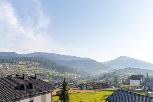 a view of a town with mountains in the background at Князів Двір in Bukovel