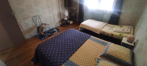 a small room with two beds and a blanket at maison grand parking privé in Tournon-Saint-Martin