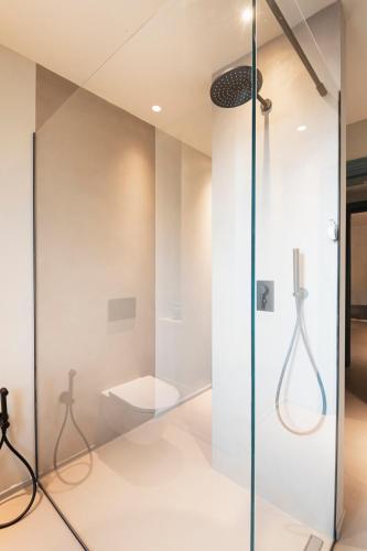 a glass shower in a bathroom with a toilet at ASILO in BAROLO in Barolo