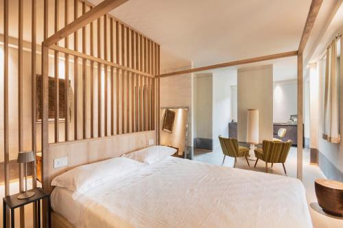 a bedroom with a bed and a table and chairs at ASILO in BAROLO in Barolo