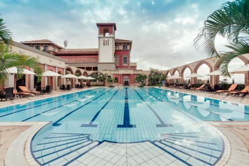a large swimming pool in front of a building at Lake Victoria Serena Golf Resort & Spa in Kigo