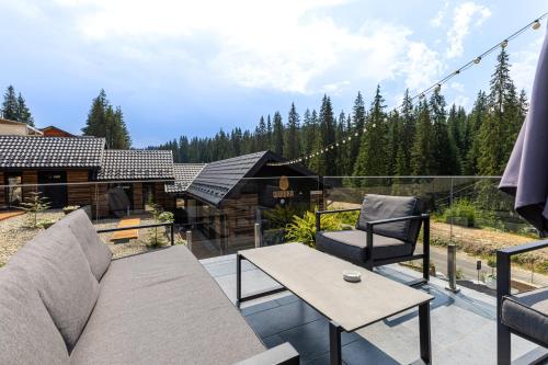 a patio with a couch and a table and chairs at Шишка in Bukovel