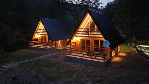 a rendering of a wooden house with lights on at Ethno Village Long Story in Kolašin