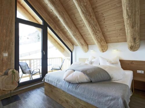 a bedroom with a bed and a large window at Chalet in Ladis by Ski Slope & Sonnenbahn in Ladis
