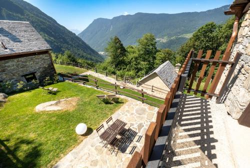 a balcony of a building with a view of the mountains at Baita Eyra - Villaggio dei Crodini in Cravegna