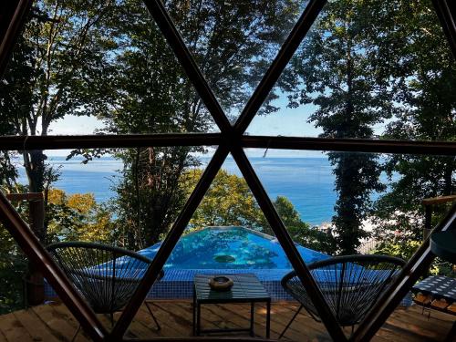 a view from a window of a hot tub at Glamping Martini Kvariati with pool in Batumi