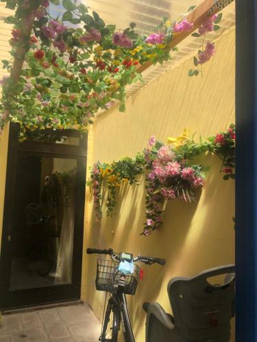 a bike parked next to a wall with flowers at Ca' Memi - Relaxing Stay in Chioggia in Chioggia