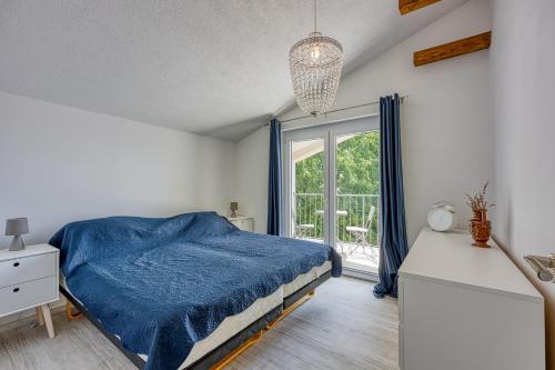a bedroom with a blue bed and a window at Apartments Galeb in Poreč