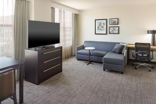 a living room with a couch and a flat screen tv at Residence Inn Washington, DC/ Downtown in Washington