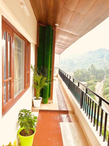 a balcony with plants on the side of a building at Ashiana at Ivy Apartments in Solan