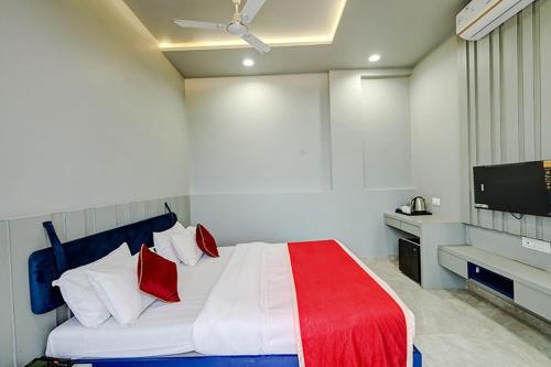 a bedroom with a bed with red and white pillows at The leaf resort Mahabaleshwar in Mahabaleshwar