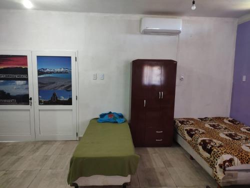 a bedroom with a bed and a dresser in it at Rinconcito Don Antonio in Tinogasta