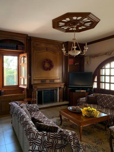 a living room with a couch and a table at Villa Georgius in Néon Rýsion