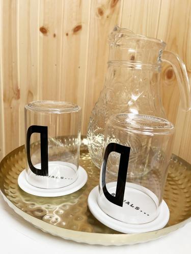 two glass mason jars sitting on a tray at Brightside Apartment in Kristiansand