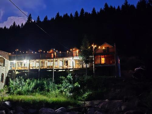 a building with lights on it at night at Eko Katun Hako in Dubočak