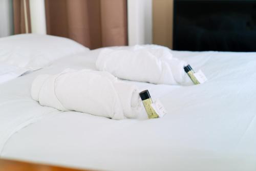 - une pile de serviettes blanches sur un lit dans l'établissement L'immersion - Super Studio - République - Paris, à Paris