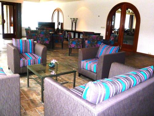 a living room with couches and a table at Hotel Het Landhuis in Oldenzaal