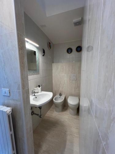 a bathroom with a sink and a toilet and a sink at La casa di Pi in Montacuto