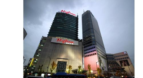a large building with a sign on the side of it at Hotel Migliore Seoul in Seoul