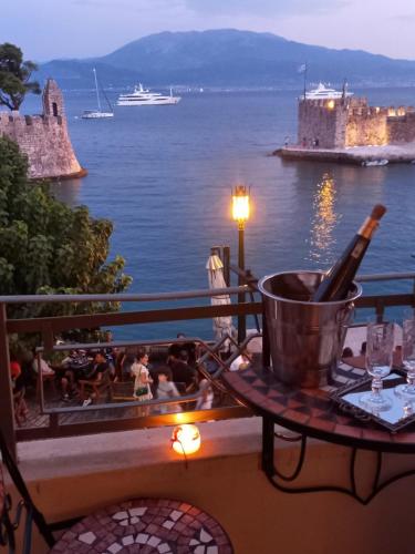 a balcony with a table with a bottle of wine at Casa da Sogno Elegant Studio in Nafpaktos
