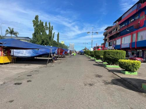 a street with a row of tents on the side of a building at Tabin Lodge Budget Stay in Lahad Datu