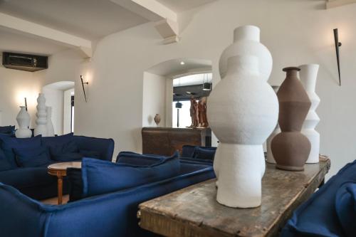 a living room with a couch and a table with vases at Grand Hotel Masseria Santa Lucia in Ostuni