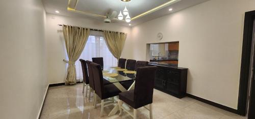 a dining room with a dining table and chairs at Haven Lodge, Islamabad in Islamabad
