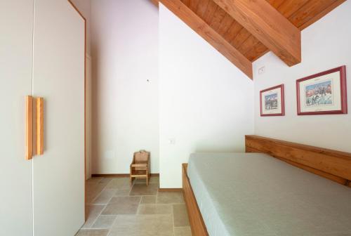 Postel nebo postele na pokoji v ubytování Baita Loki - Villaggio dei Crodini