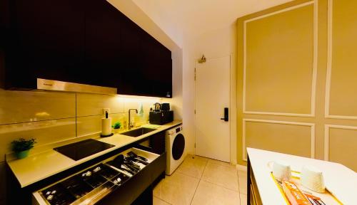 a kitchen with a sink and a washing machine at Axon Residence KLCC - KL HOME in Kuala Lumpur
