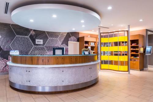 a lobby of a pharmacy with a large light fixture at SpringHill Suites Temecula Valley Wine Country in Temecula