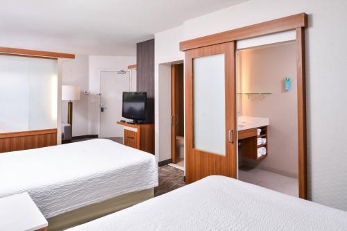 a hotel room with two beds and a television at SpringHill Suites Temecula Valley Wine Country in Temecula