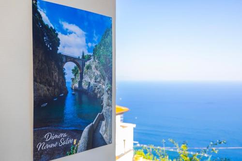 a poster of a bridge over a body of water at Salvo's House in Furore