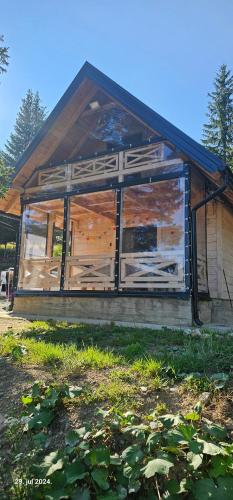 a house with wooden doors and windows at Brvnara Marinković na Sekulićima in Sekulić 