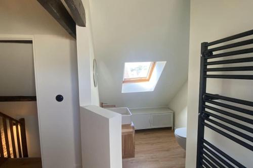 a bathroom with a sink and a toilet in a room at La perle-Maison de pêcheur à Saint-Aubin-sur-Mer in Saint-Aubin-sur-Mer